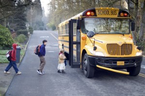 Kids getting on a school bus